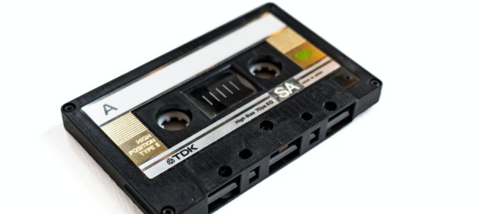 a black and white cassette tape recorder on a white background