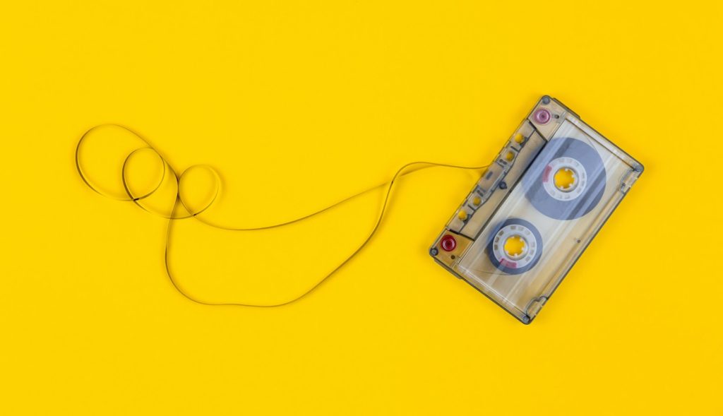 gray cassette tape on yellow surface