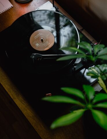 black turntable on brown wooden table